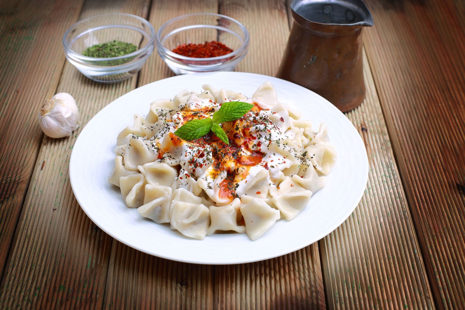 Plates of traditional Turkish food. Manti with tomato sauce 
