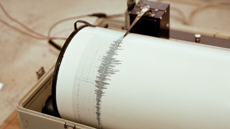 PHOTO: EAST NEWS/SCIENCE PHOTO LIBRARY  Seismograph recording activity of the  Merapi volcano, Java, Indonesia. This  device detects and records ground movements (seismic activity), which in this  case are due to an active volcano. The print out (lower centre) is the previous  days activity.