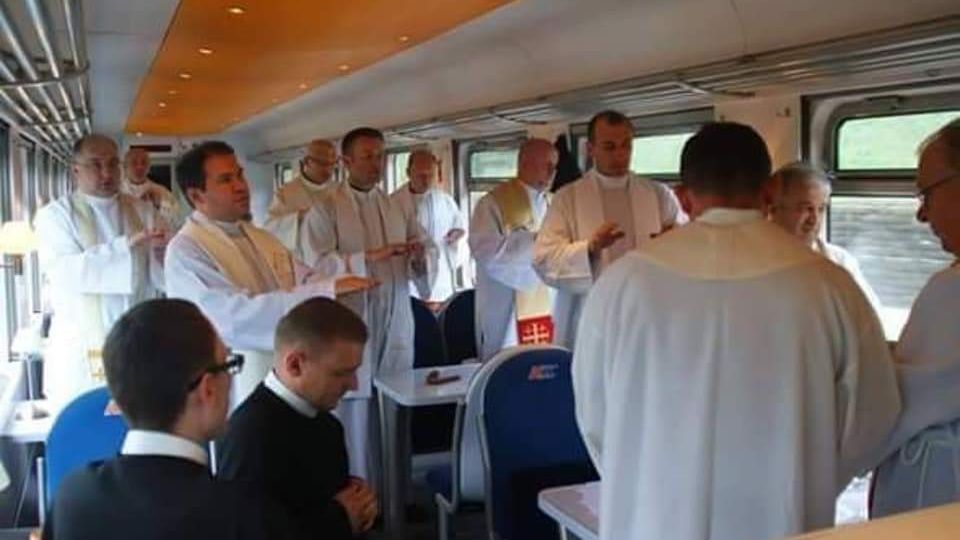 Na jednym ze zdjęć widać, jak kilkunastu księży odprawia mszę świętą w wagonie restauracyjnym.
