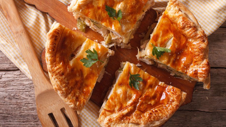 Homemade chicken pie sliced close-up on the table. horizontal view from above