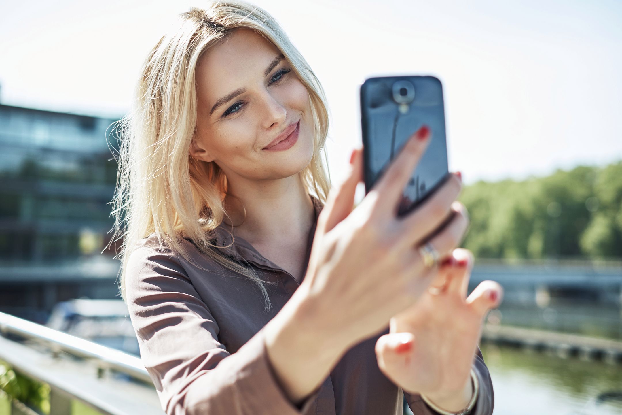 Portrait of a blond lady taking a selfie 