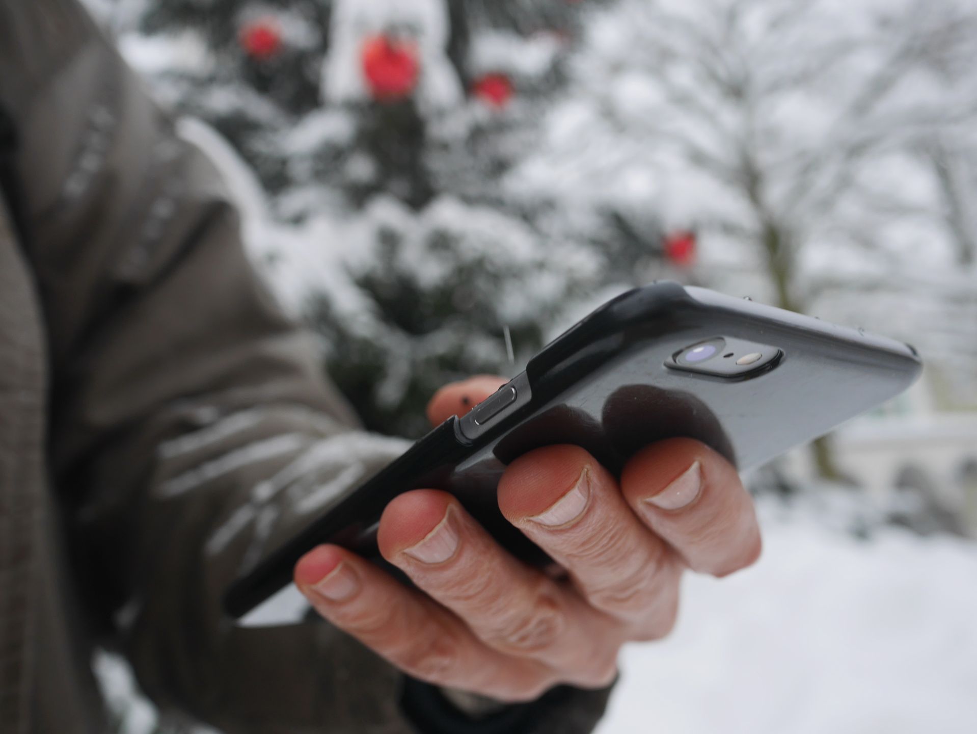 tablet in hand in winter smartphone winter christmas snow 