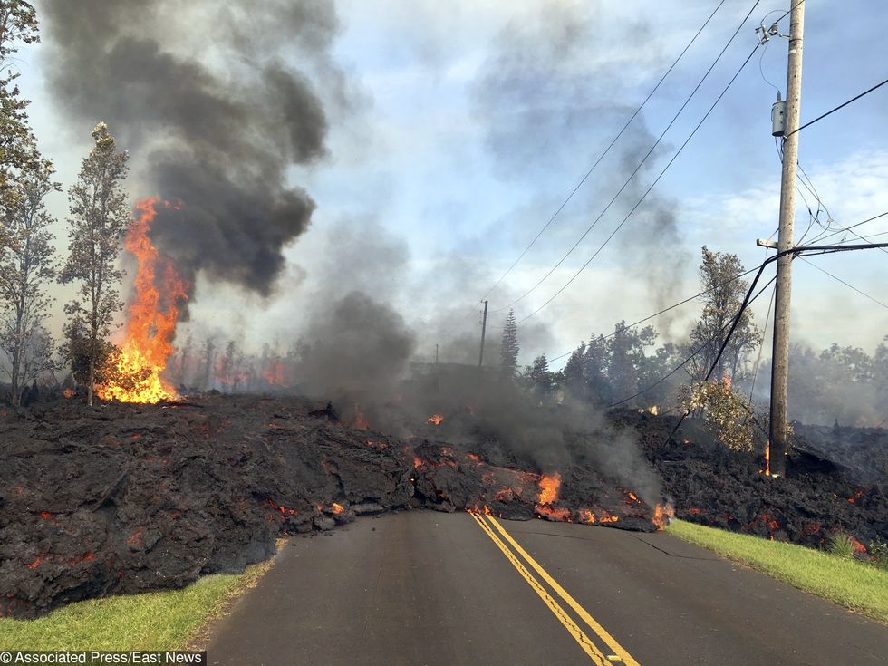 In this Saturday, May 5, 2018, photo provided by the U.S. Geological Survey, lava from Fissure 7 slowly advances to the northeast on Hookapu Street in the Leilani Estates subdivision in Pahoa, Hawaii. The Kilauea volcano sent more lava into Hawaii communities Friday, a day after forcing more than 1,500 people to flee from their mountainside homes, and authorities detected high levels of sulfur gas that could threaten the elderly and people with breathing problems. (U.S. Geological Survey via AP) 