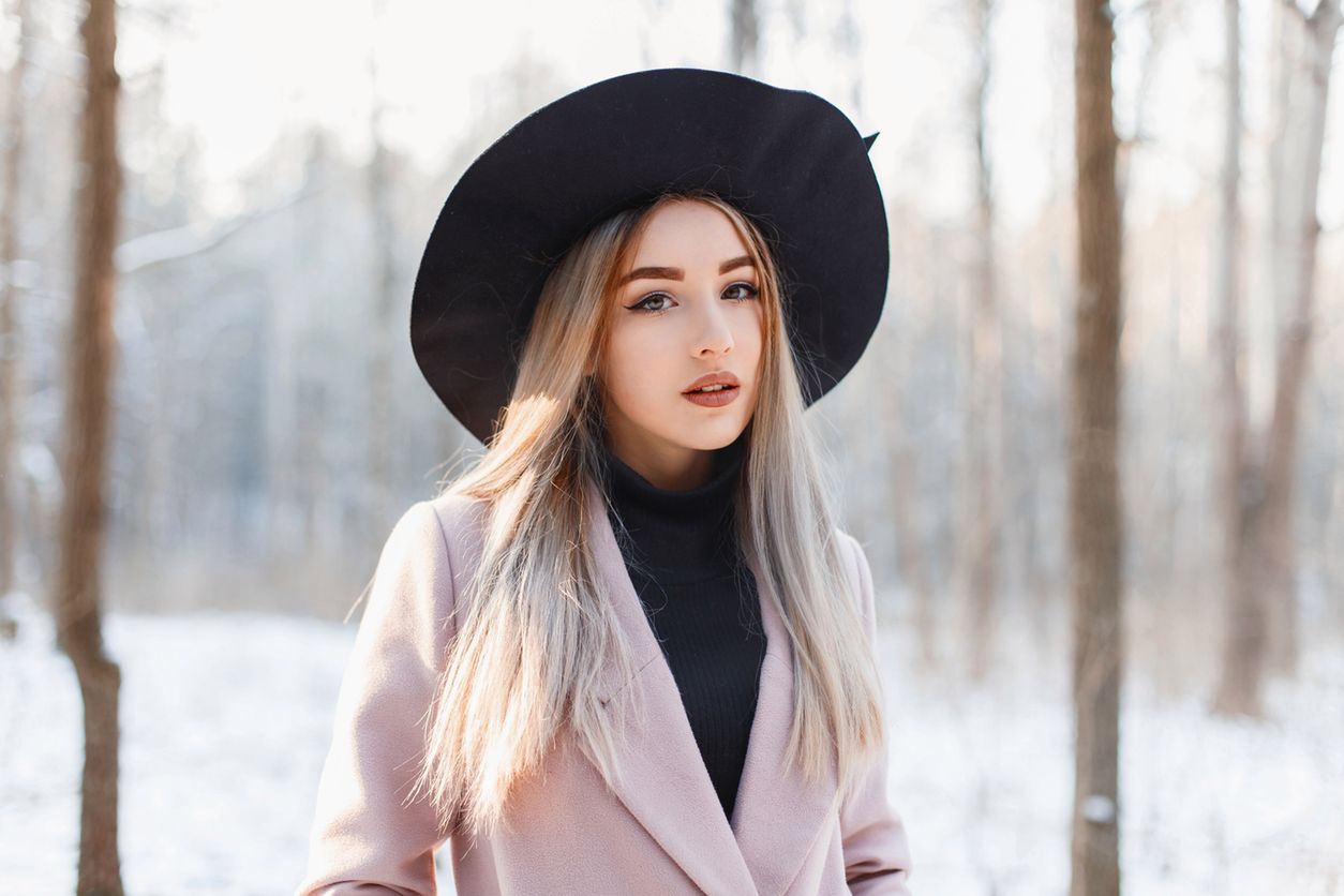 Beautiful woman on the background of a winter forest with snow 