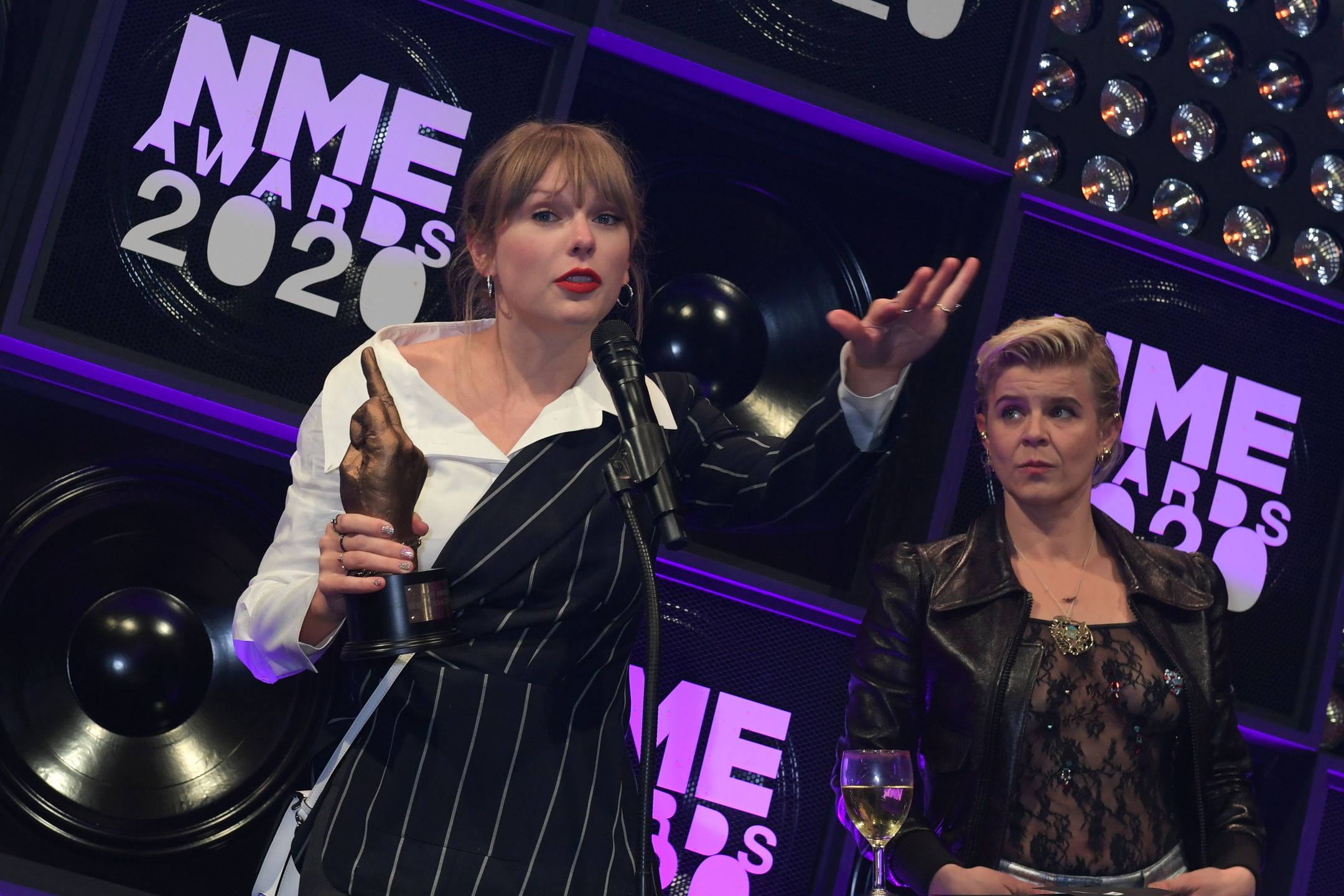 LONDON, ENGLAND - FEBRUARY 12:  Taylor Swift, winner of the award for Best Solo Act In The World, and Robyn, winner of Songwriter Of The Dedade, attend The NME Awards 2020 at the O2 Academy Brixton on February 12, 2020 in London, England.  (Photo by David M. Benett/Dave Benett/Getty Images) 