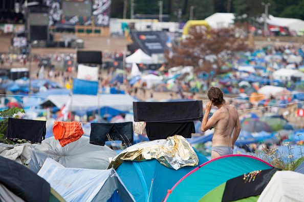 KOSTRZYN, POLAND - AUGUST 04: A man is seen among tents at the 2017 Woodstock Festival Poland on August 4, 2017 in Kostrzyn, Poland. The three-day rock music festival, now in its 23rd year, brings together hundreds of thousands of music fans from across Central Europe. Festival organizers charge the fans no admission. (Photo by Omer Messinger/Getty Images) 