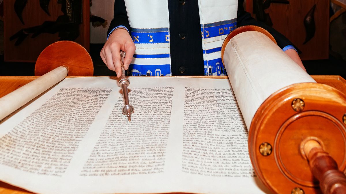 Jewish man dressed in ritual clothing 5 SEPTEMBER 2015 USA NY Hand of boy reading the Jewish Torah at Bar Mitzvah Bar Mitzvah Torah reading