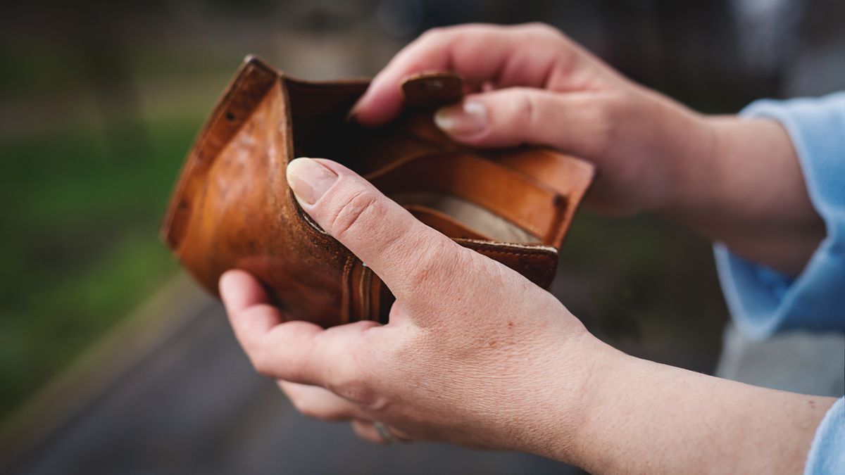 Empty wallet in the hands of woman. Poverty concept
