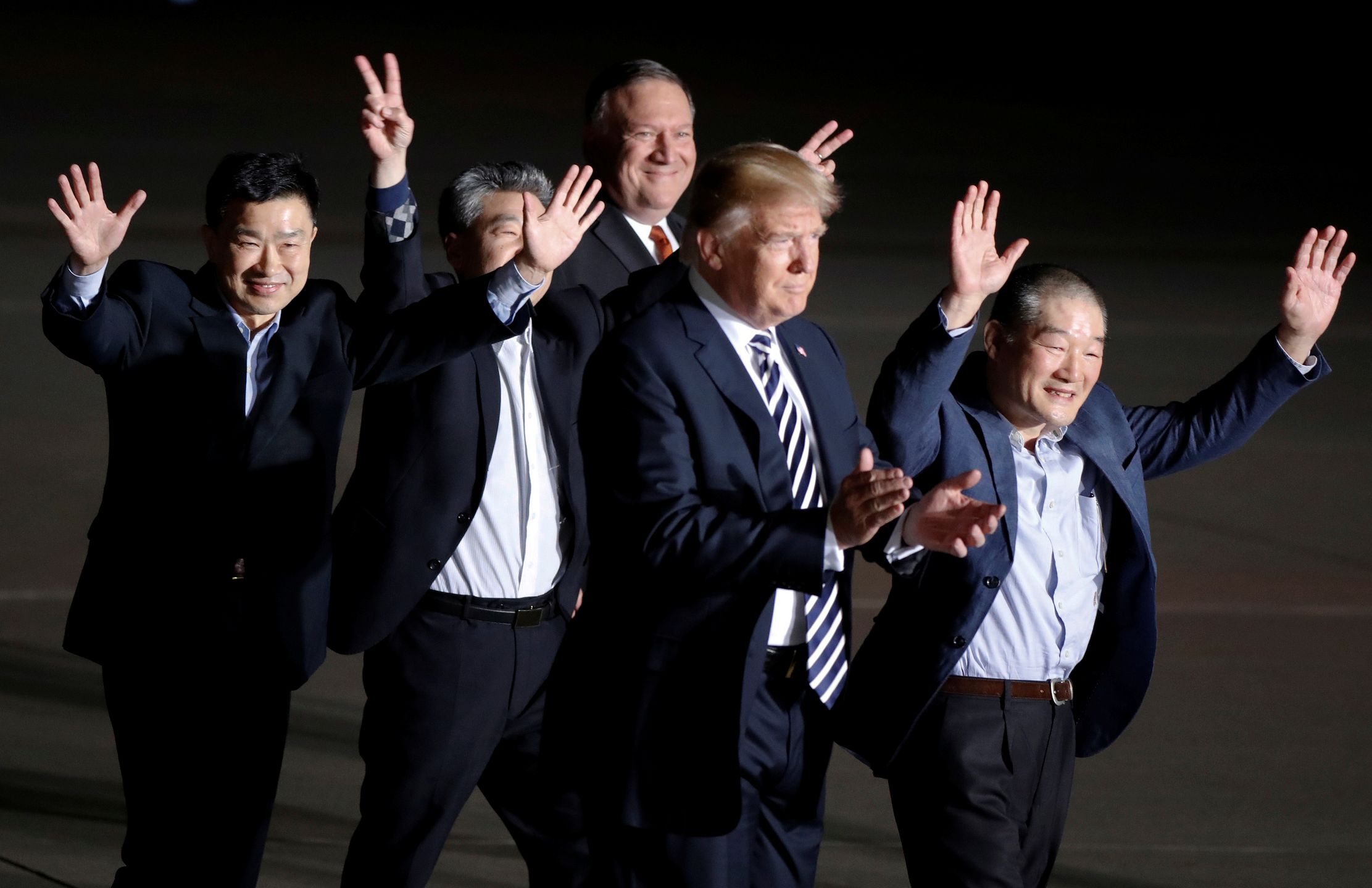 The three Americans formerly held hostage in North Korea gesture next to U.S.President Donald Trump and Secretary of State Mike Pompeo, upon their arrival at Joint Base Andrews, Maryland, U.S., May 10, 2018.  REUTERS/Jim Bourg 