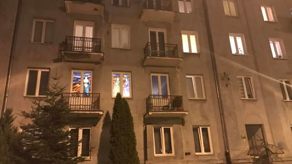 Gdy zapada zmrok, dwa okna na pierwszym piętrze zaczynają mienić się kolorami