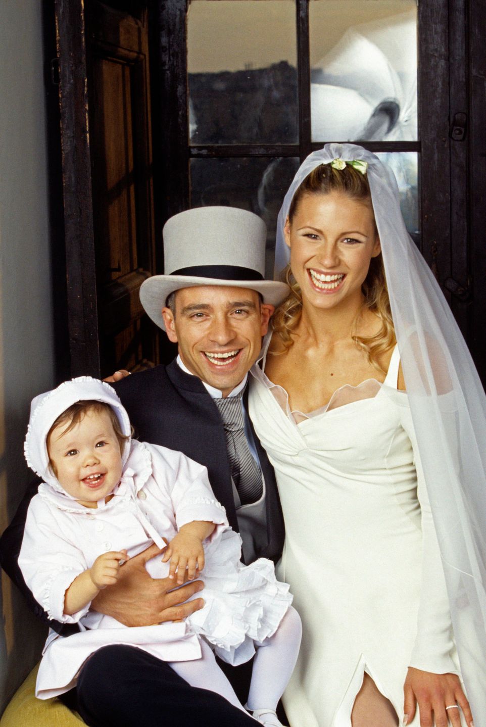 Italian singer-songwriter Eros Ramazzotti, Swiss-born Italian TV presenter, model and actress Michelle Hunziker and their daughter Aurora smiling during their wedding party at the Castello Odescalchi. Bracciano, 24th April 1998 