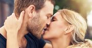 Young couple deeply in love sharing a romantic kiss, closeup profile view of their faces