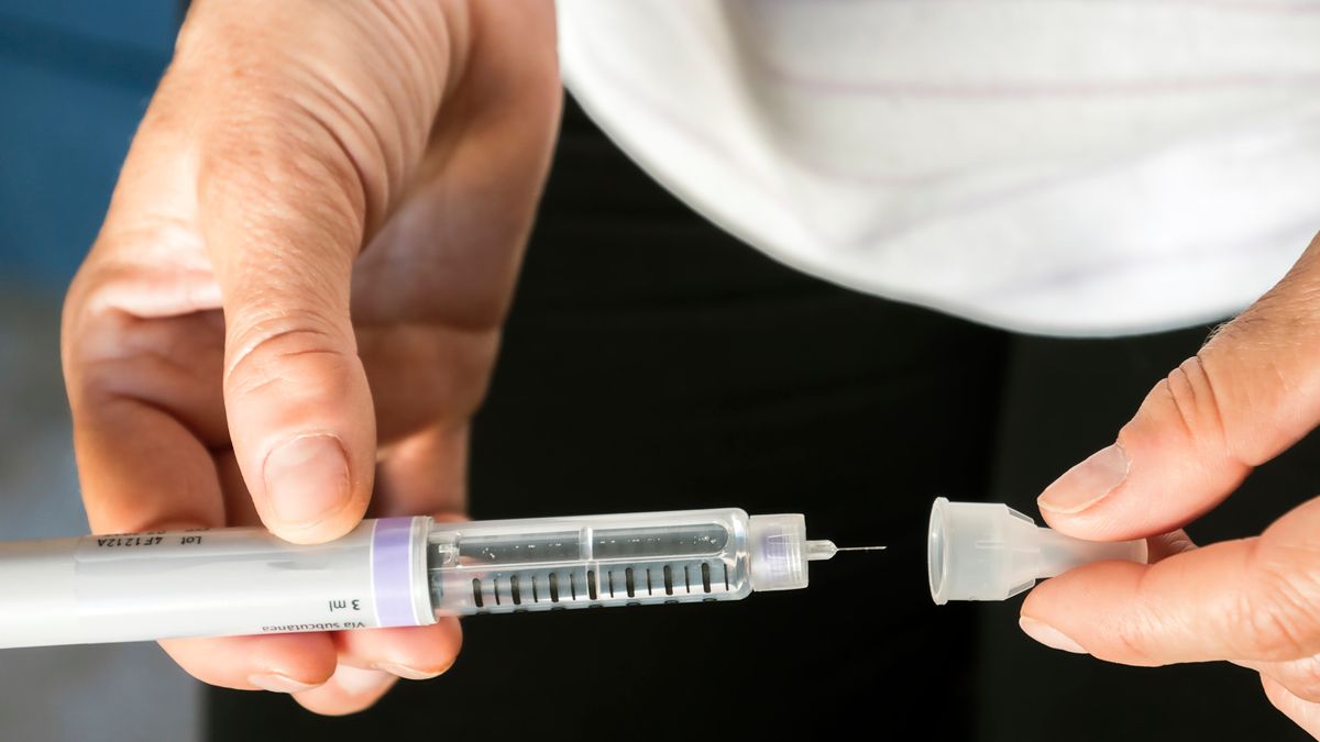 Woman examining treatment of insulin, conceptual image