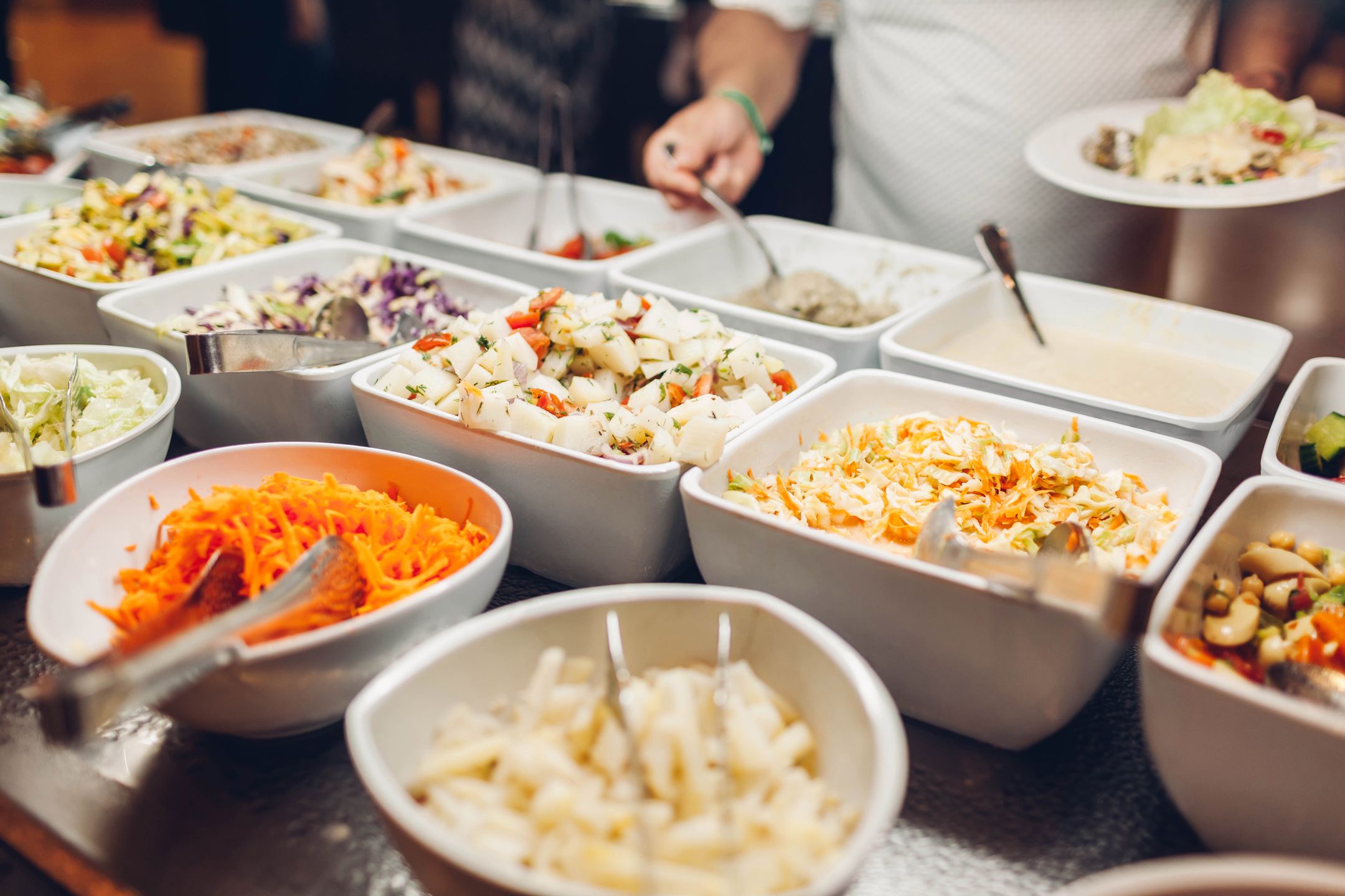 Assortment of fresh dishes displayed in hotel buffet. Variety of food in canteen ready for dinner. Vegetable salads. All inclusive 