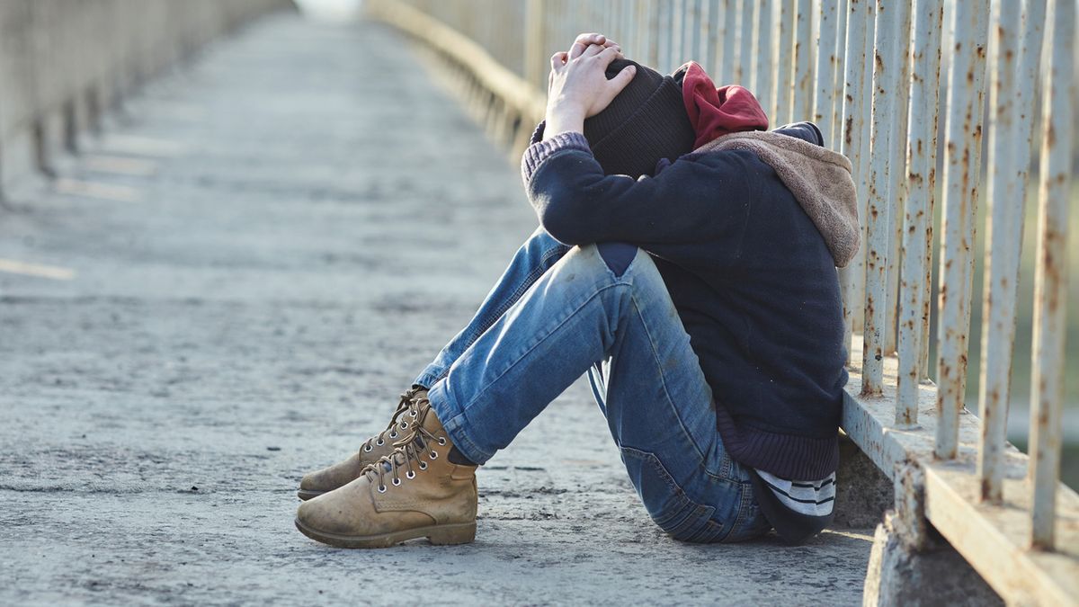 young homeless boy sleeping on the bridge, poverty, city, street