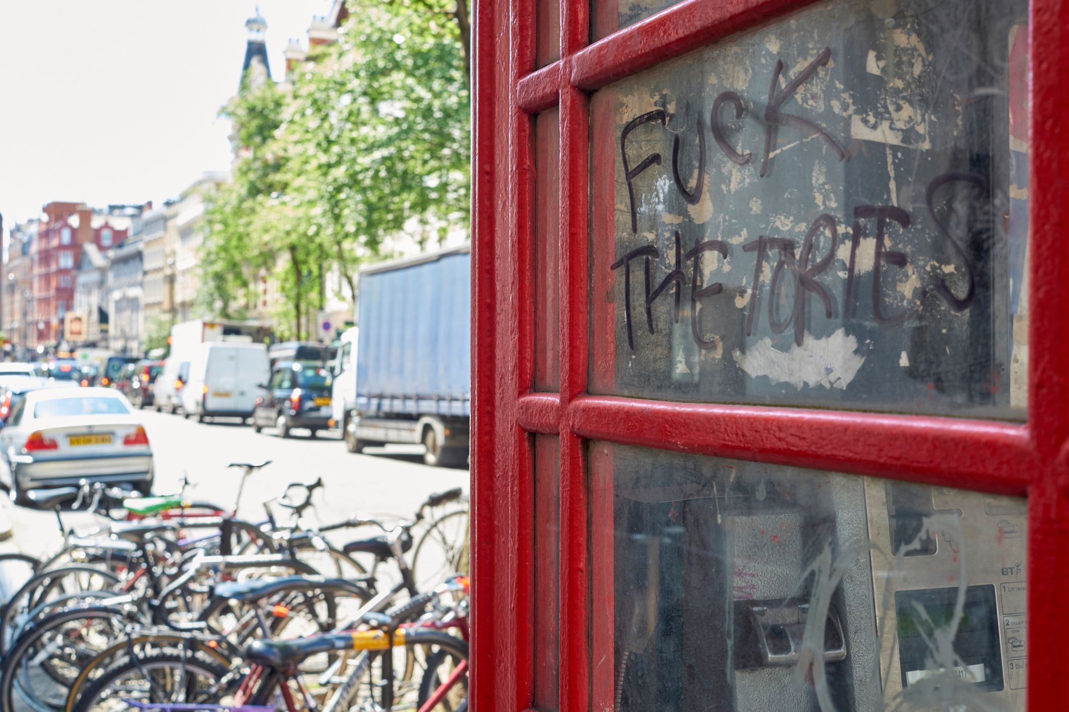 LONDON, UK - MAY 13: Detail of defaced public telephone booth with "fuck the Tories" grafitti. May 13, 2015 in London. The Conservative Party, known as Tories, won the last general elections in 2015. 