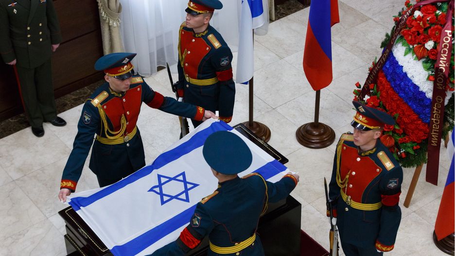 Rosyjscy żołnierze nad trumną z ubraniem zaginionego Izraelczyka